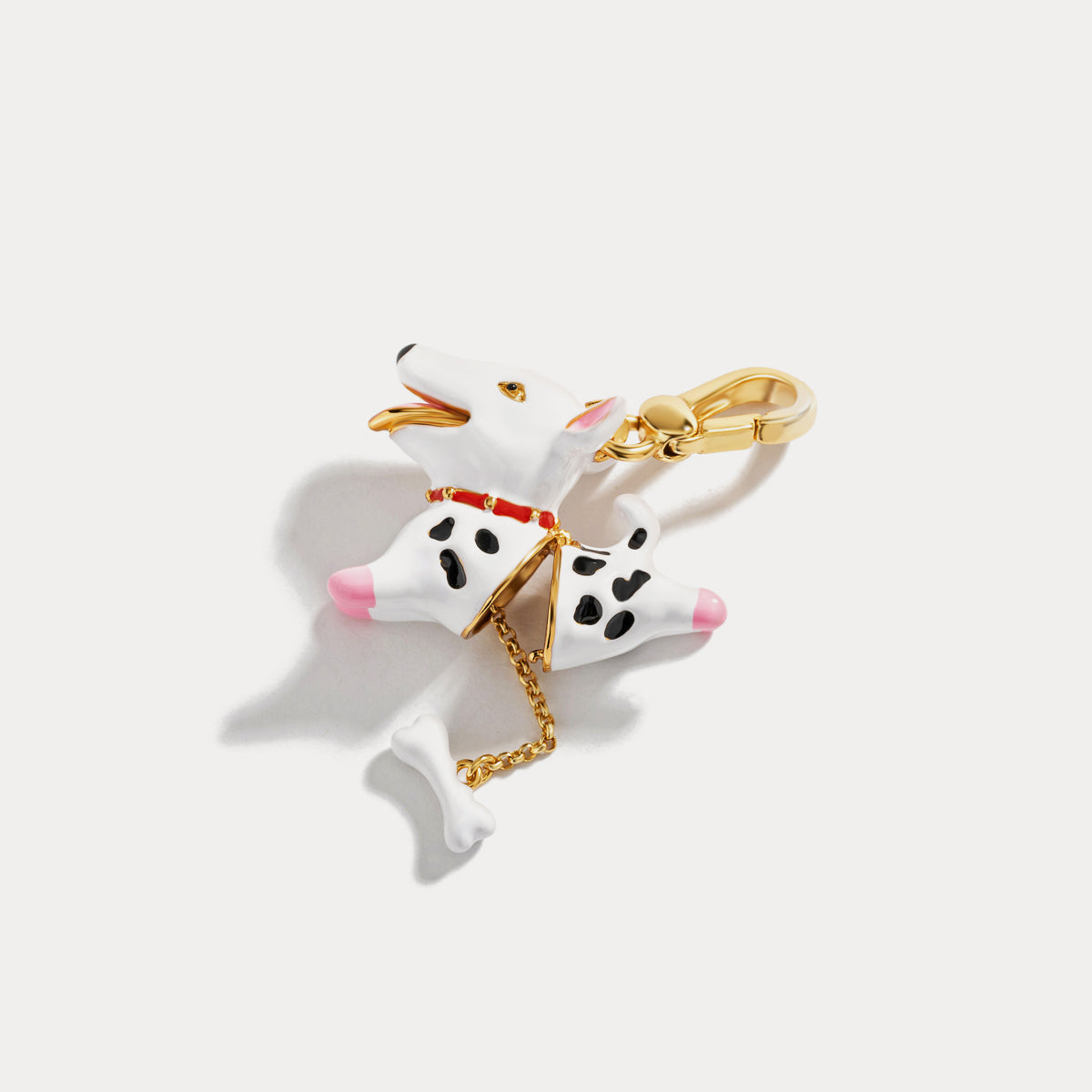 Dalmatian dog pendant locket opened to reveal gold interior and bone charm