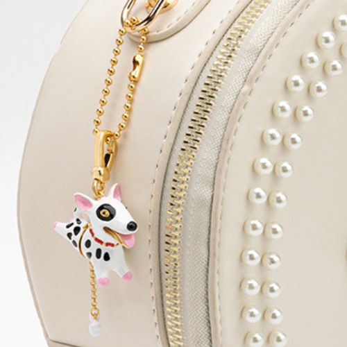 Dalmatian dog locket pendant used as a bag charm with white pearl handbag