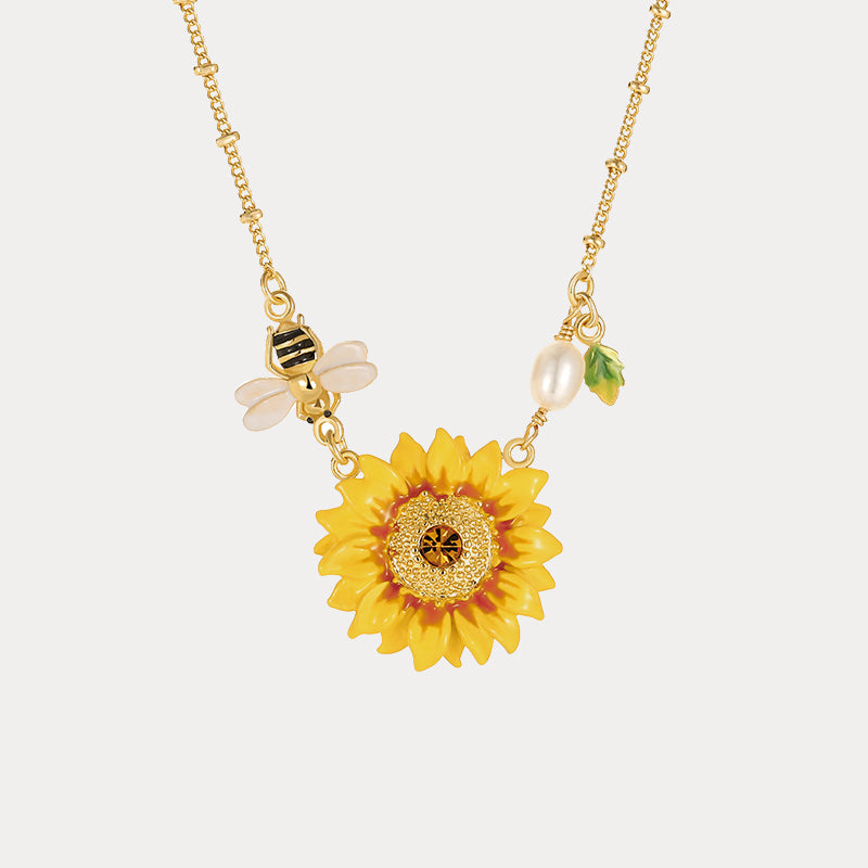 Intricate sunflower pendant with golden center, bee charm, and pearl detail