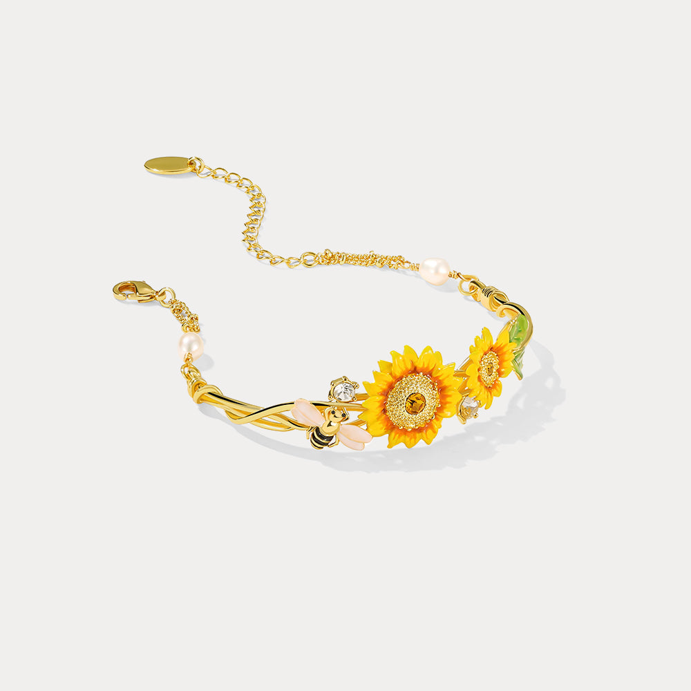 Detailed product image of sunflower cuff bracelet with gold-plated structure, bee charm, and crystals