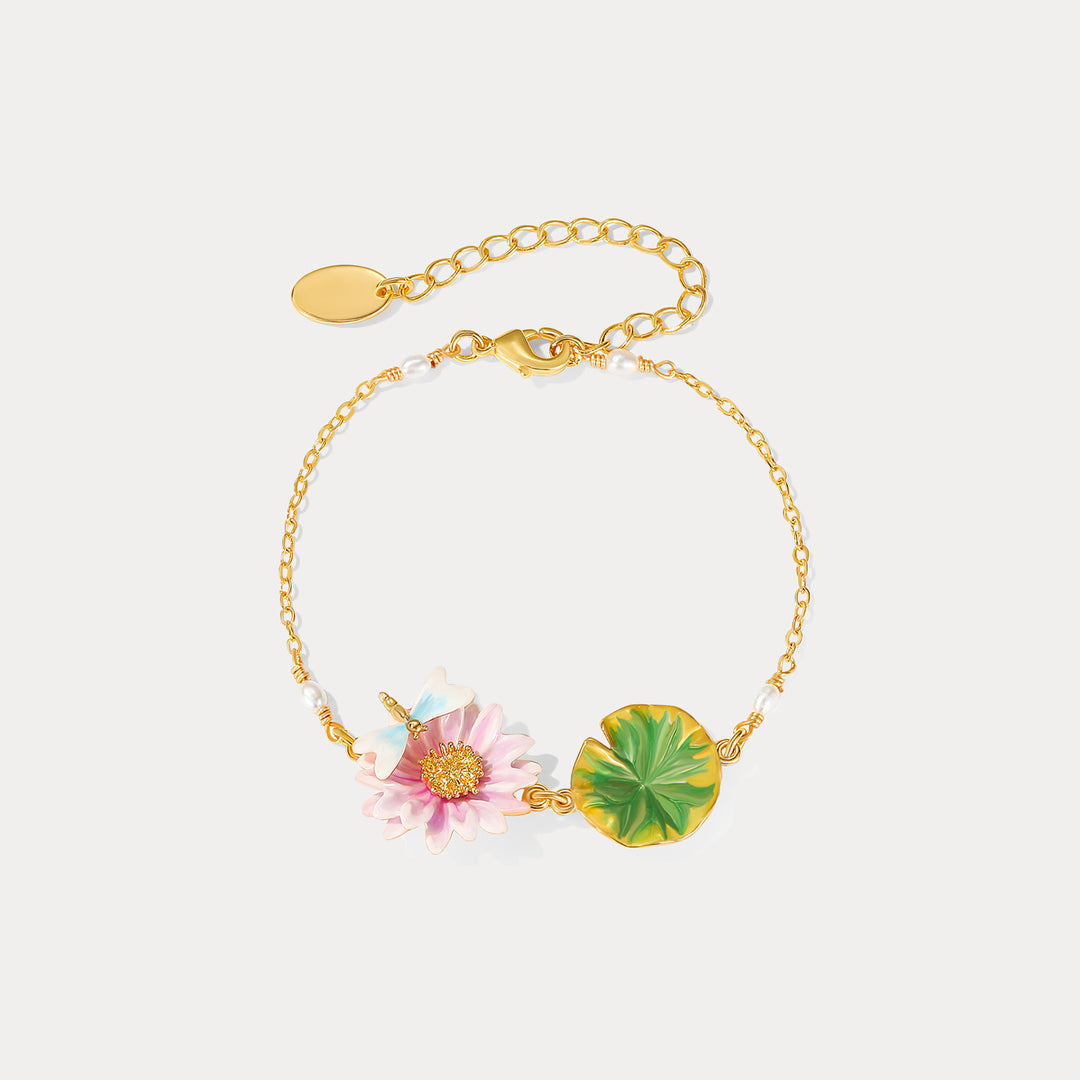 Front-facing image of lotus dragonfly bracelet featuring detailed pink lotus enamel flower and green lotus leaf