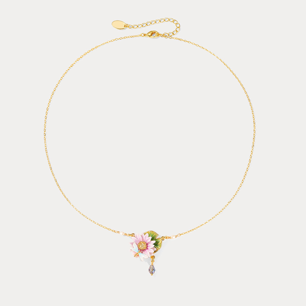 Full necklace layout with lotus flower pendant, dragonfly detail, and crystal drop charm on gold chain.