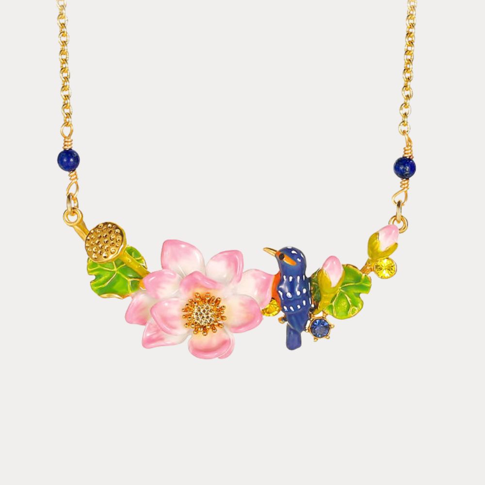 Close-up view of the Kingfisher Lotus Necklace showcasing a blue bird and pink enamel lotus flower on a gold chain