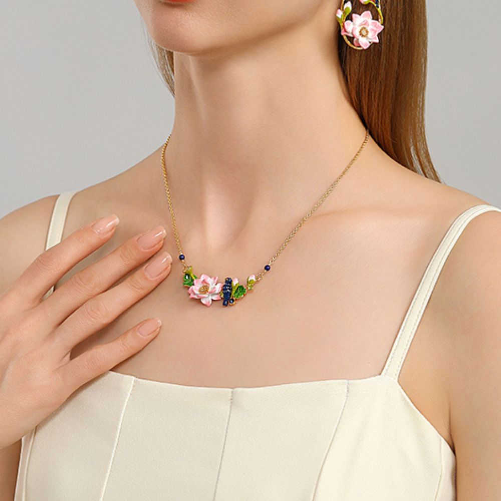 Woman wearing Kingfisher Lotus Necklace paired with matching floral earrings in a lifestyle setting