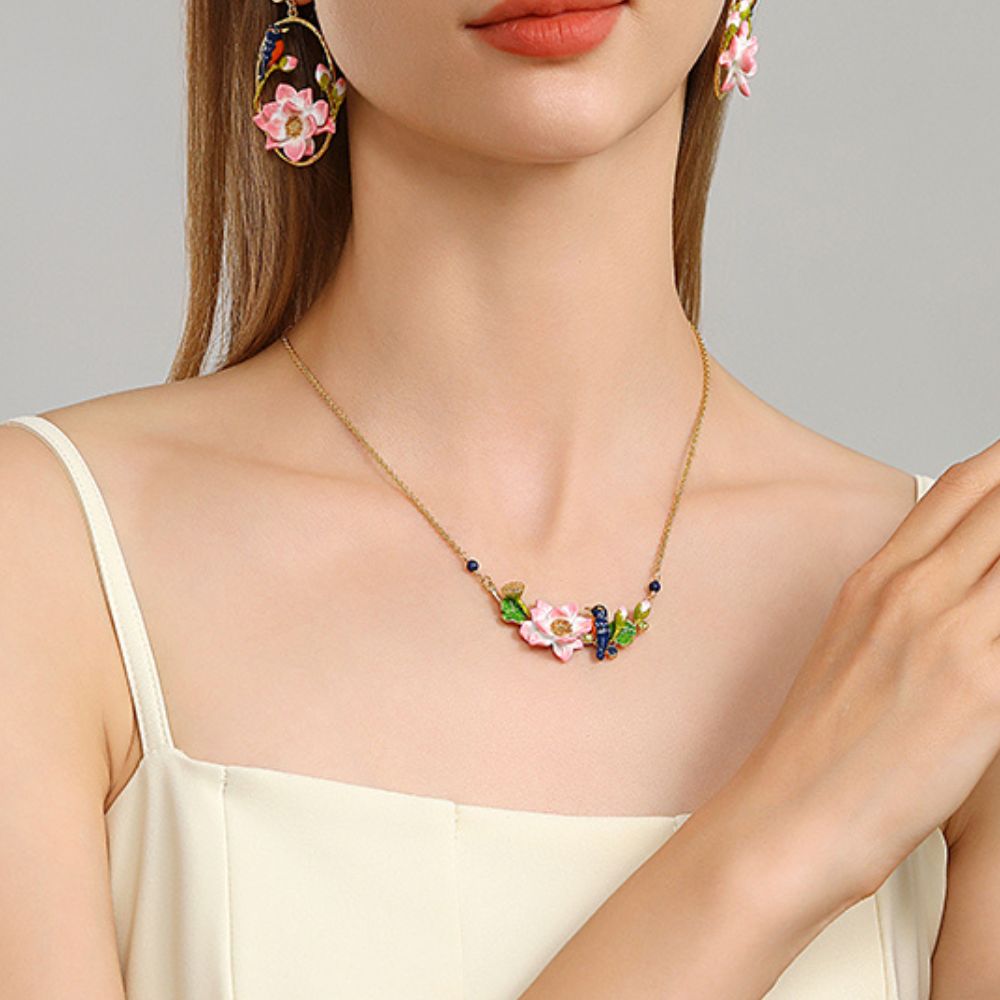Model wearing Kingfisher Lotus Necklace featuring a central pink lotus flower and blue bird design