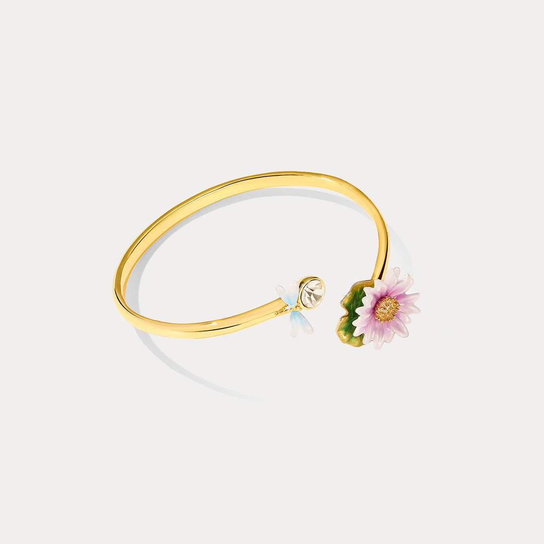 Front angle view of the Lotus Dragonfly Bracelet showcasing a pink lotus flower and dragonfly on a gold open bangle.