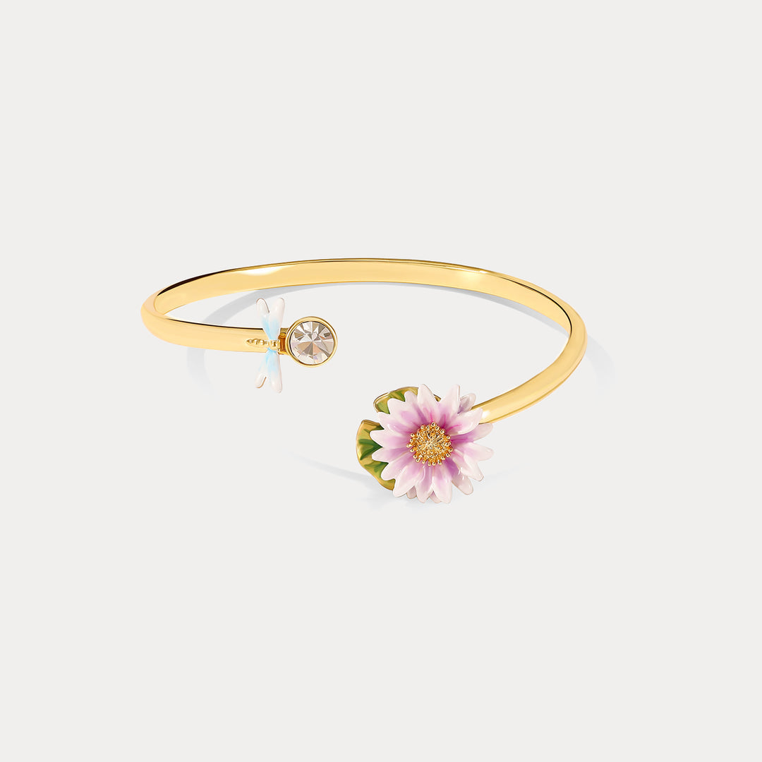 Side profile view of the Lotus Dragonfly Bracelet highlighting the gold bangle, lotus flower, and crystal dragonfly detail.