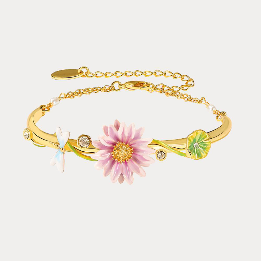 Close-up of Lotus Dragonfly Bracelet featuring a pink lotus flower, green lily pad, and crystal-studded gold chain