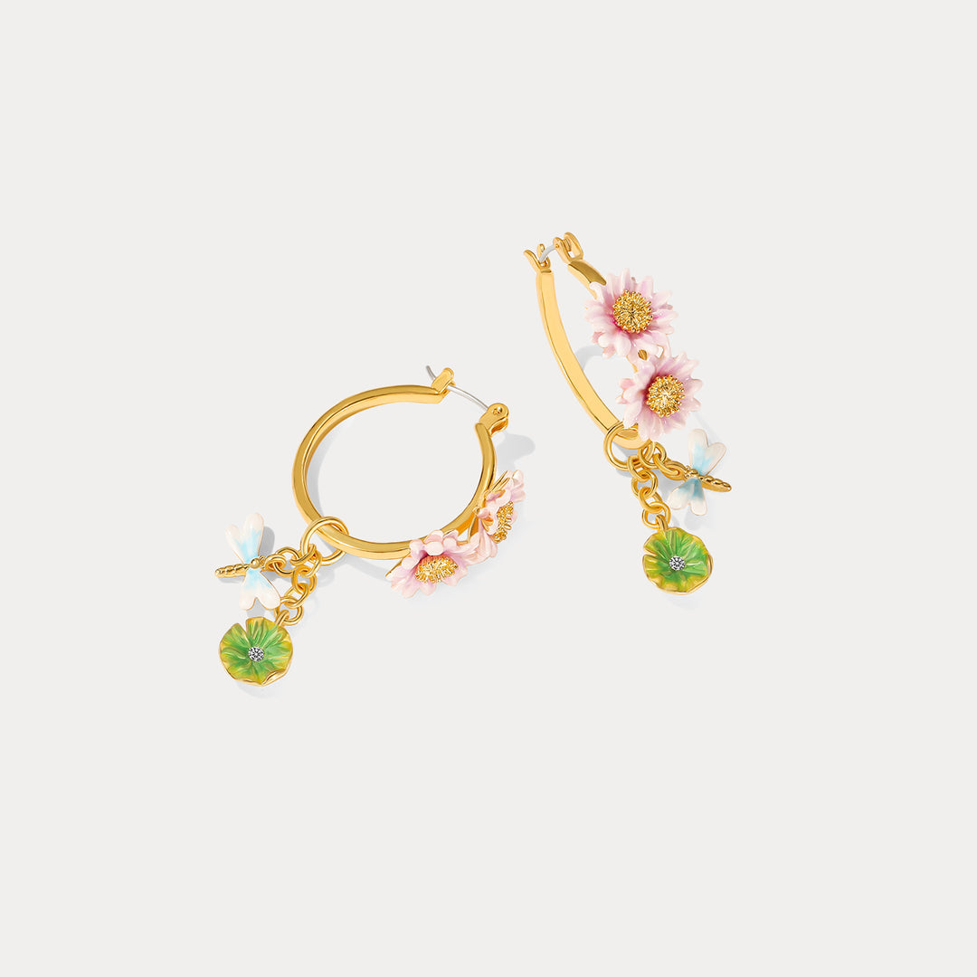 Side view of Lotus Dragonfly Hoop Earrings showing intricate floral details and dangling charms with a gold hoop design.