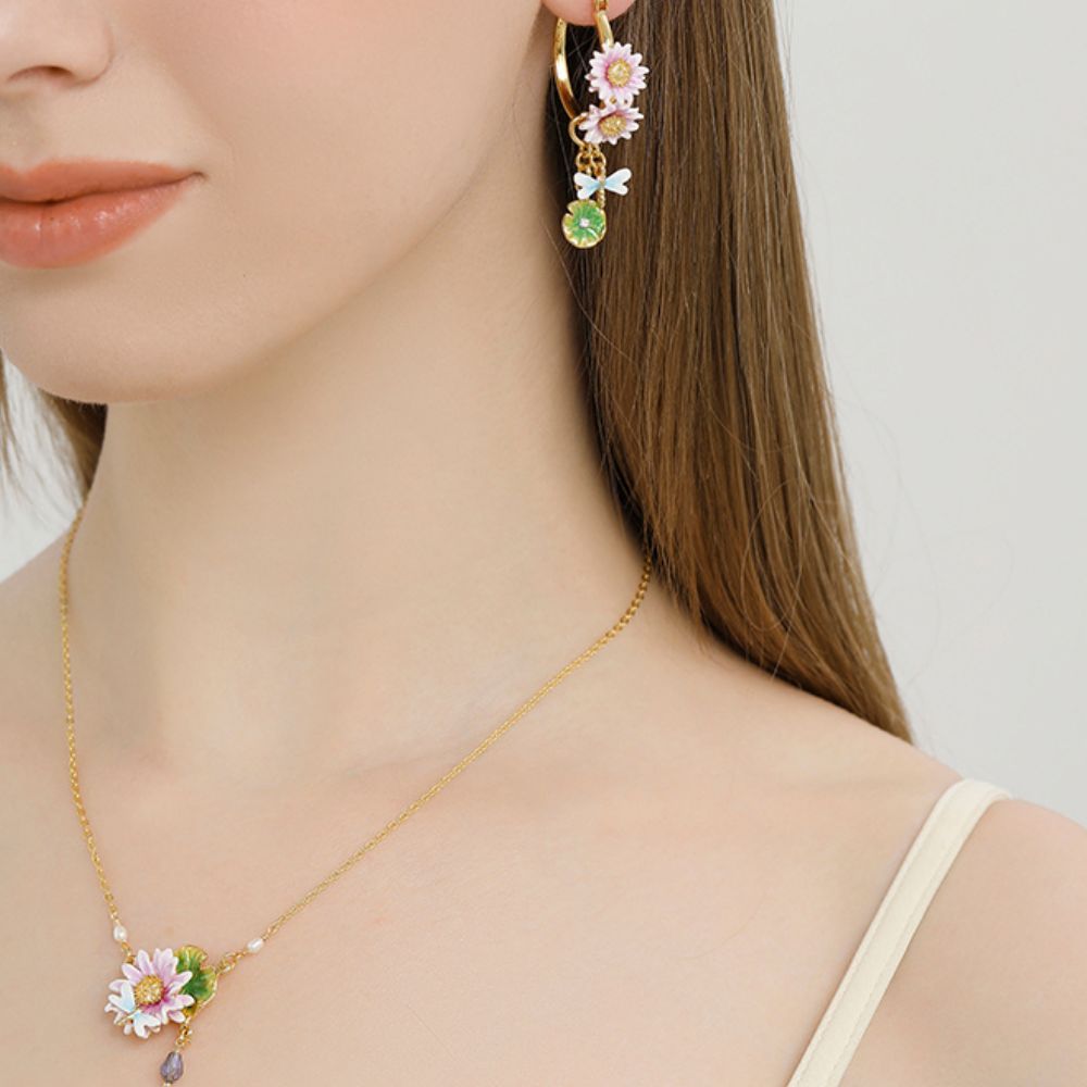 A model wearing Lotus Dragonfly Hoop Earrings with a matching floral necklace, showing an elegant coordinated jewelry look.