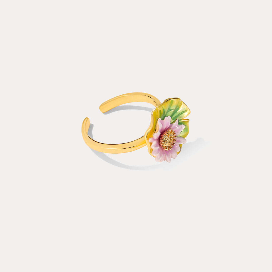 Side angle of gold lotus flower ring featuring pink enamel petals and green leaf design.