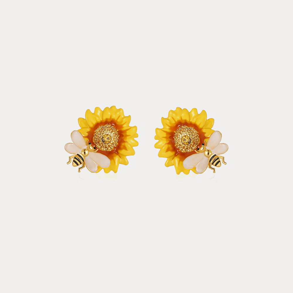Front-facing close-up of sunflower-shaped stud earrings with delicate bee design from Verdivine