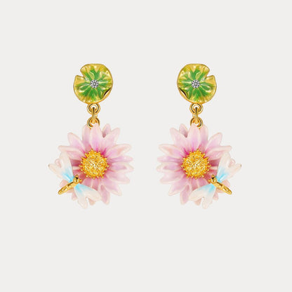 Close-up view of the Lotus Dragonfly Earrings with pink lotus flowers and delicate blue dragonflies, accented by green lily pad studs.