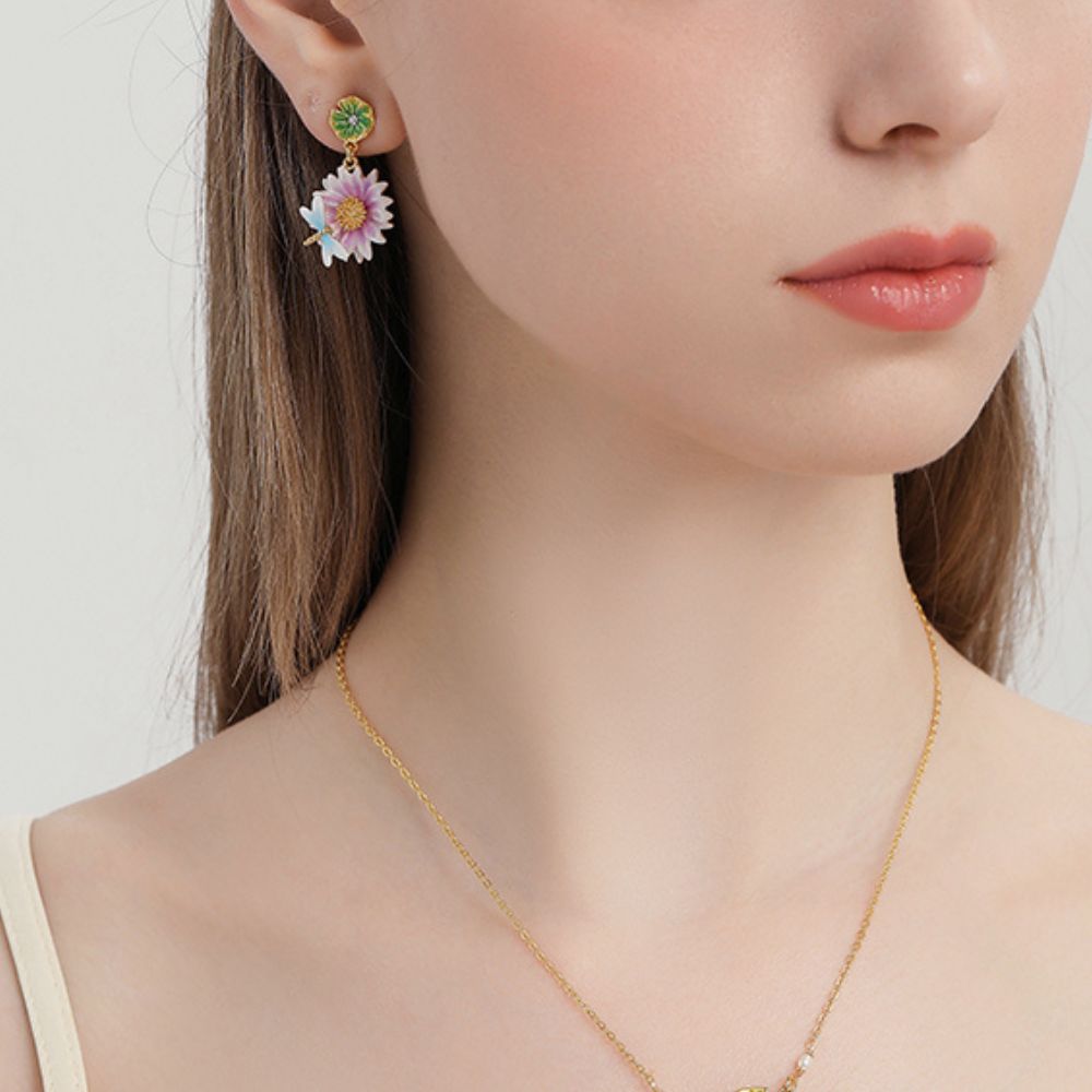 Close-up view of the Lotus Dragonfly Earrings with pink lotus flowers and delicate blue dragonflies, accented by green lily pad studs.