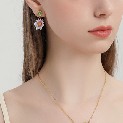 Close-up view of the Lotus Dragonfly Earrings with pink lotus flowers and delicate blue dragonflies, accented by green lily pad studs.