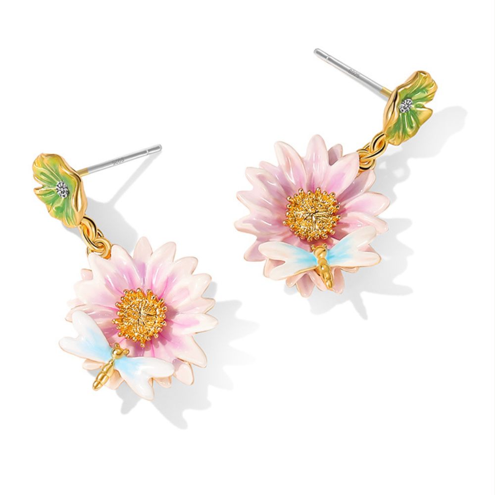 Close-up view of the Lotus Dragonfly Earrings with pink lotus flowers and delicate blue dragonflies, accented by green lily pad studs.