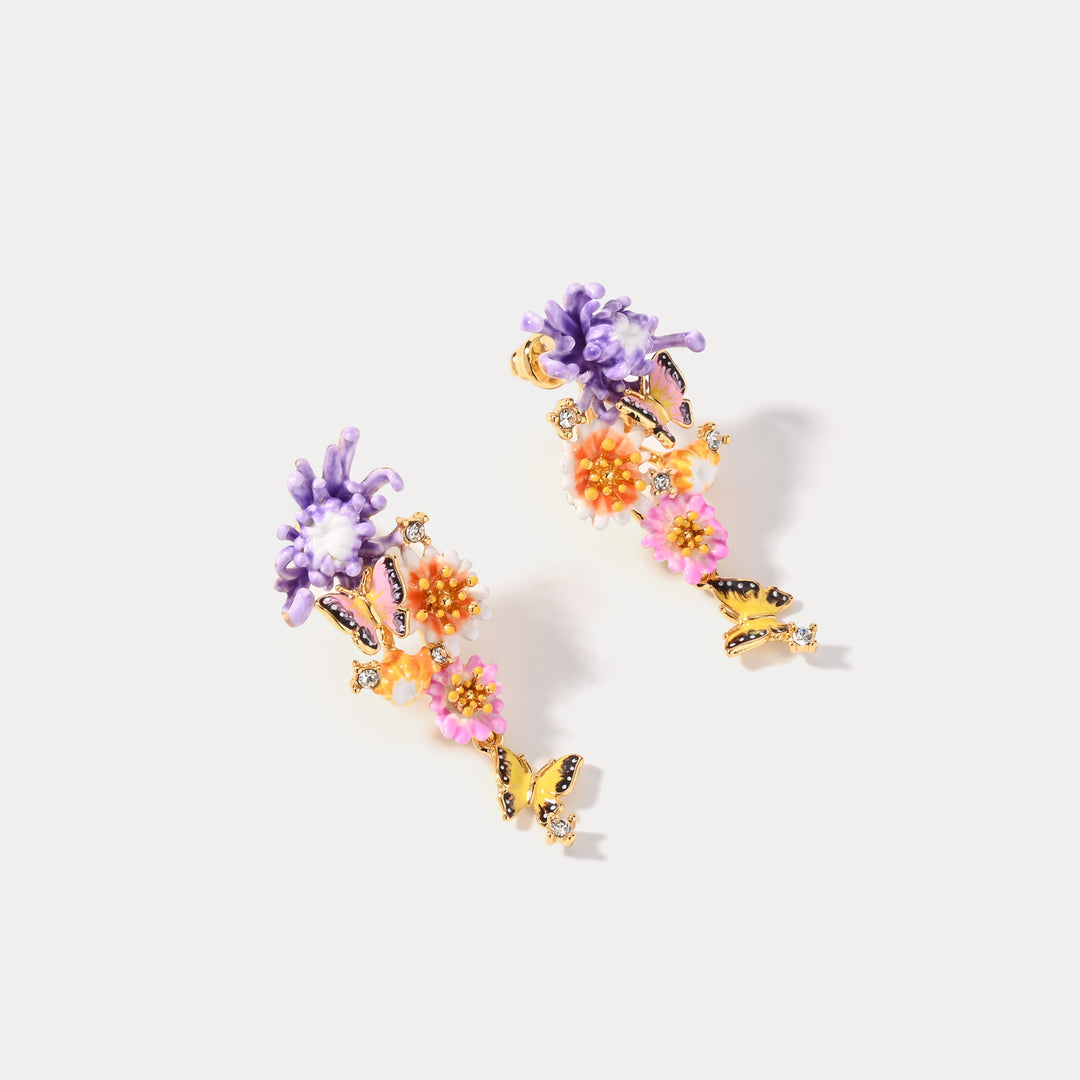 Pair of Daisy Butterfly Drop Earrings featuring purple flowers and orange blossoms with butterfly accents