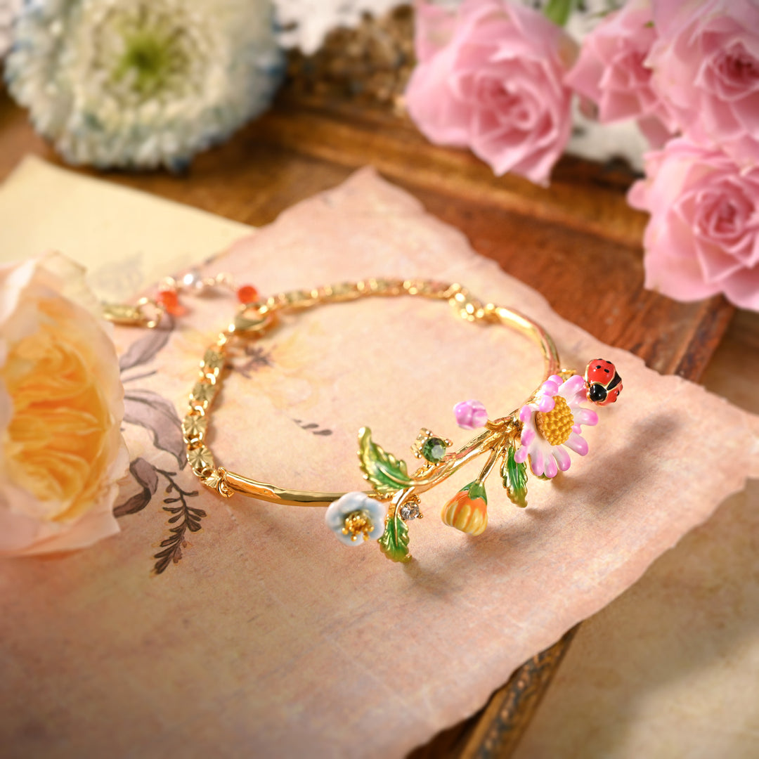 Artistic flat lay of Daisy Ladybug Bracelet with floral background and soft lighting