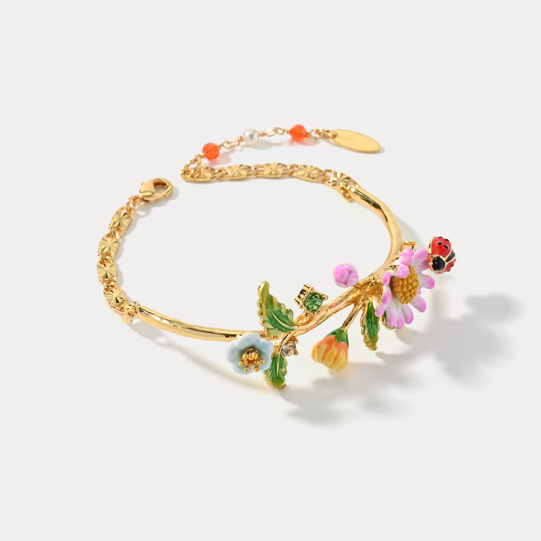 Close-up of Daisy Ladybug Bracelet showing floral and ladybug design on white background