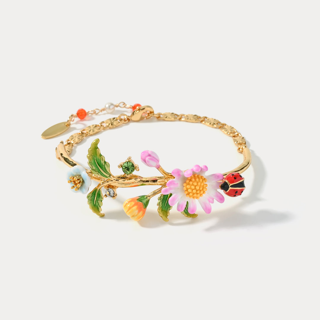Full view of Daisy Ladybug Bracelet showcasing flowers, ladybug charm, and gold chain details