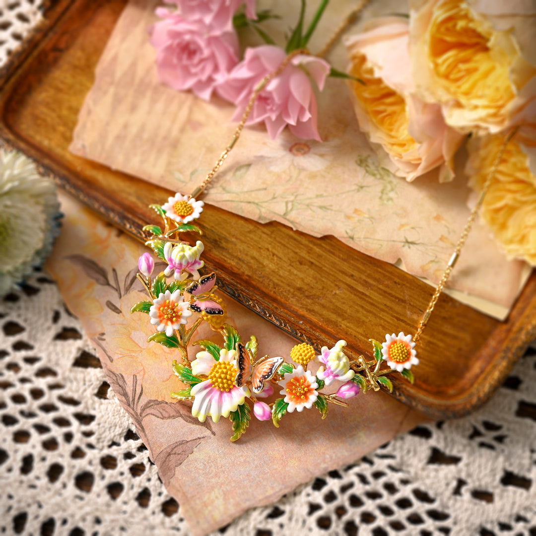 Daisy Ladybug Necklace displayed with pink roses and vintage decor