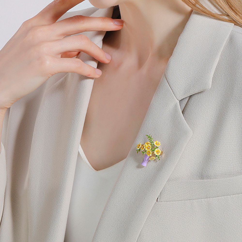  Yellow flower bouquet brooch in a purple vase worn on a blazer, styled as a fashion accessory