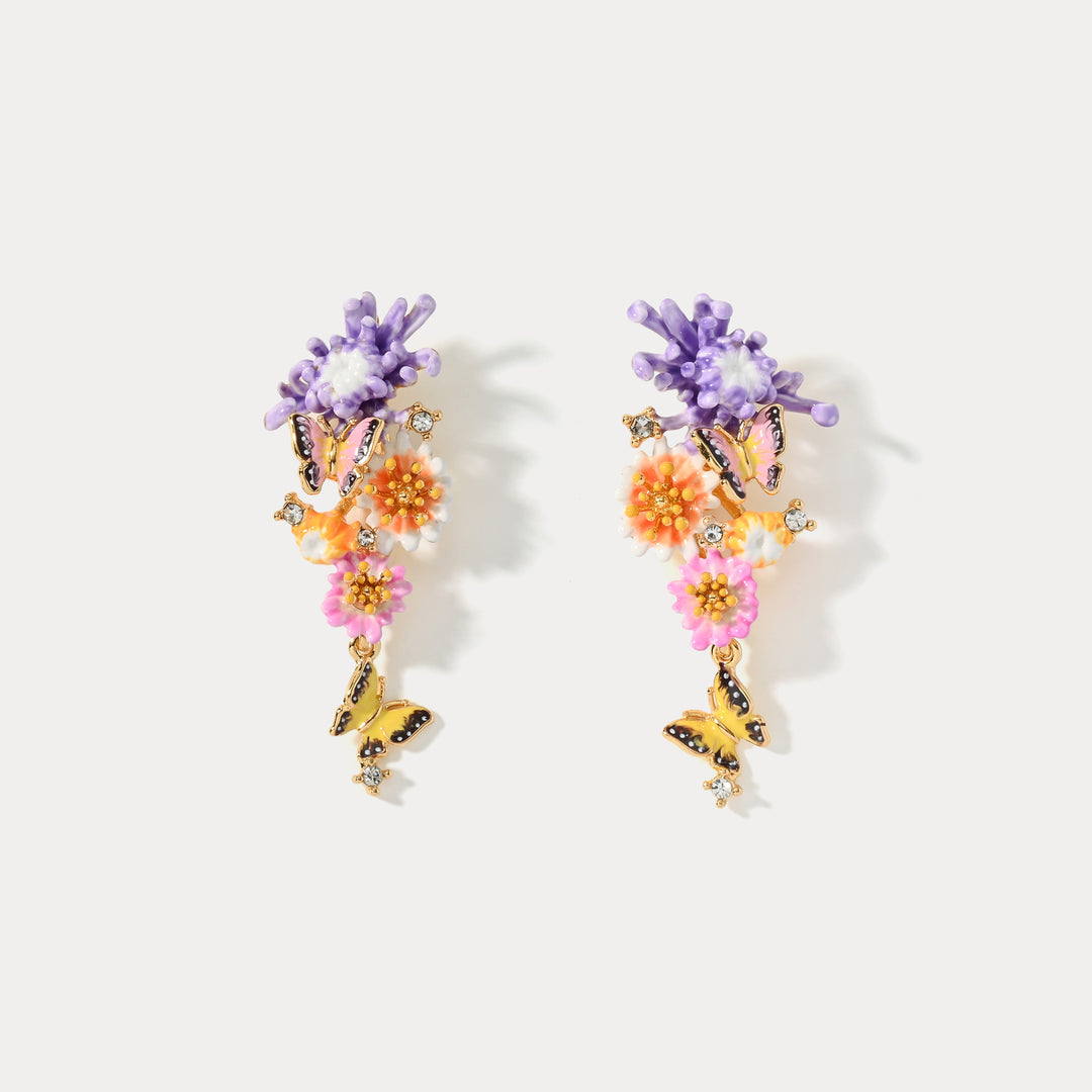 Front view of Daisy Butterfly Drop Earrings showing purple floral tops and dangling butterfly charms