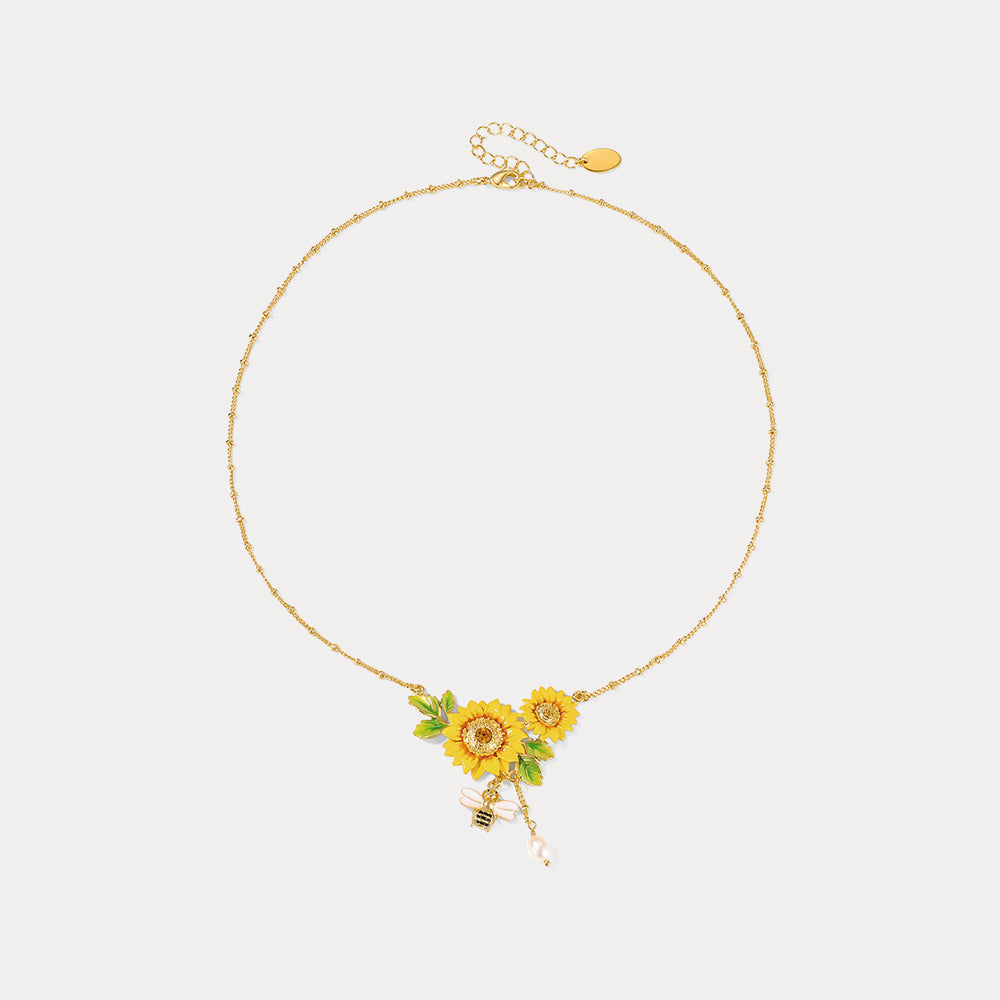 Sunflower necklace displayed in full circle, featuring golden chain, floral center, and dangling bee charm