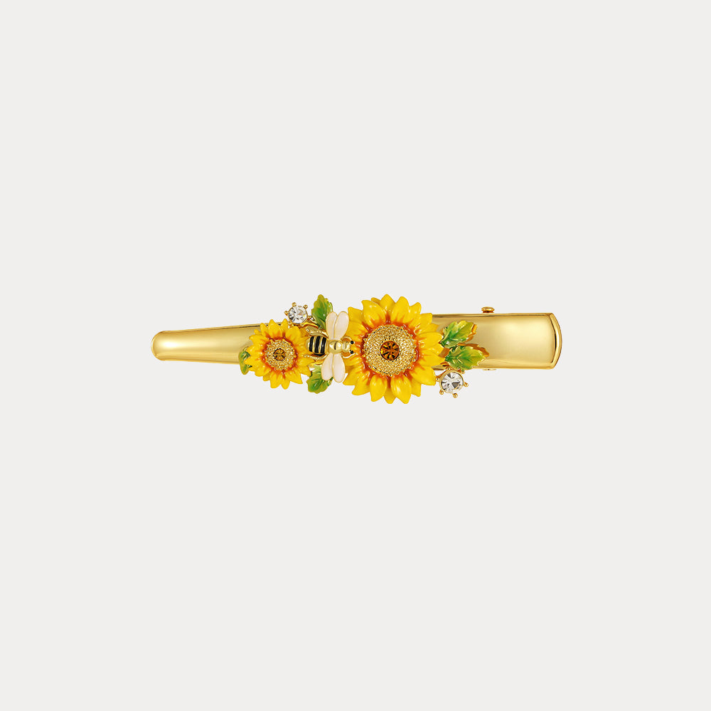 Horizontal view of sunflower hairpin showcasing enamel flowers, bee charm, and green leaf accents
