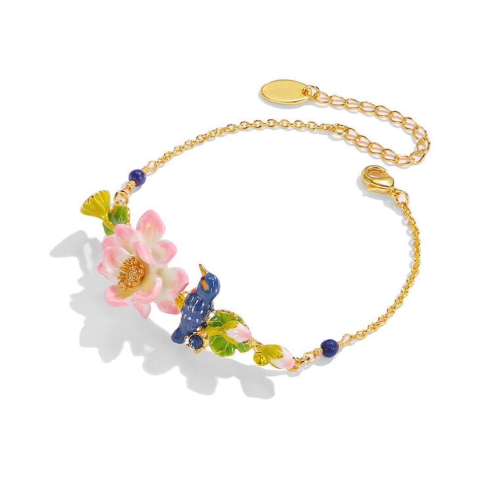 Detailed top view of the Kingfisher Lotus Bracelet showing the central pink lotus and blue bird surrounded by green leaves on a white background.