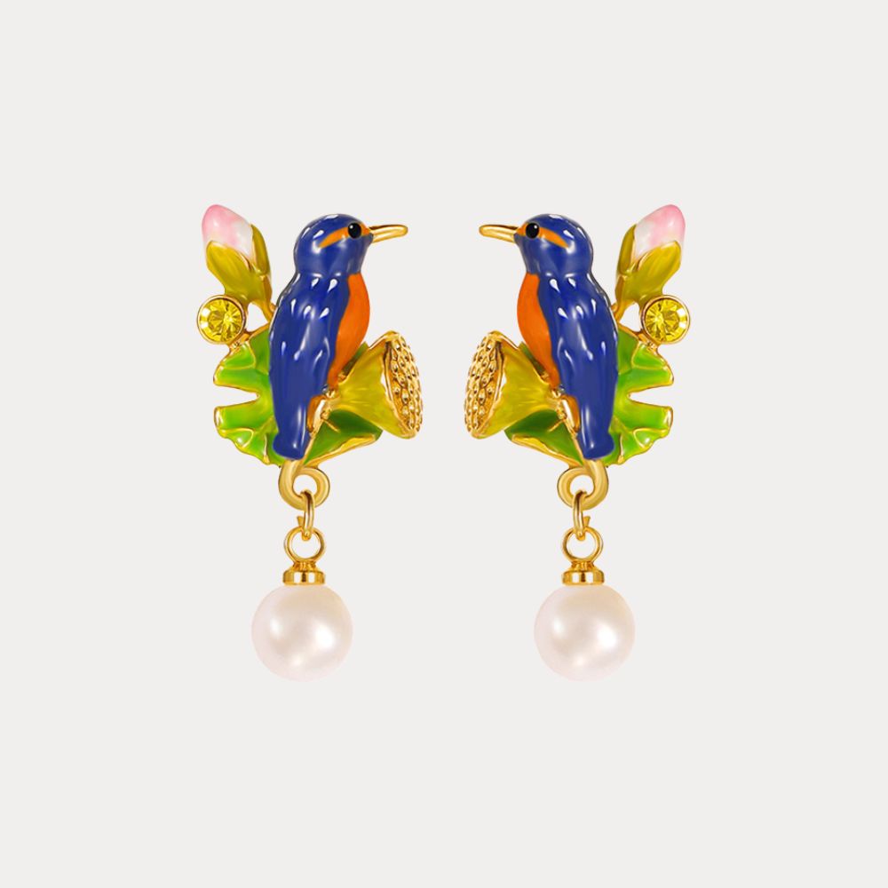 Close-up of a model wearing one Kingfisher Lotus Earring, showing the detailed bird and lotus motif with dangling pearl accent.