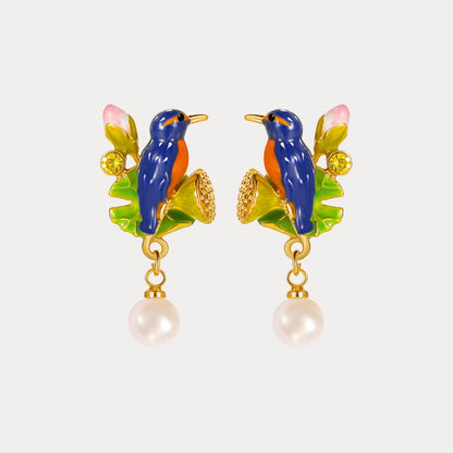 Close-up of a model wearing one Kingfisher Lotus Earring, showing the detailed bird and lotus motif with dangling pearl accent.