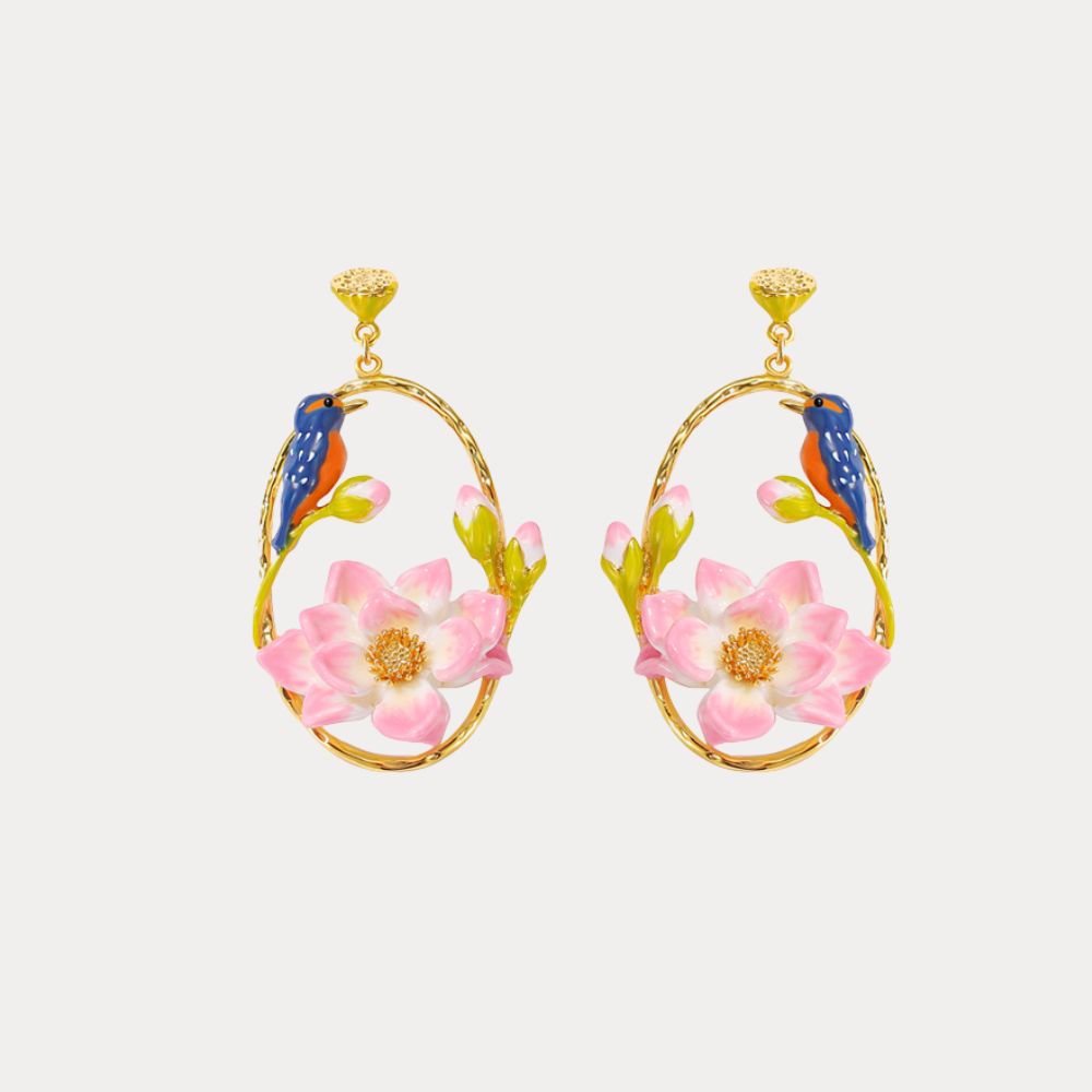 Close-up of floral hoop earrings with blue kingfisher and blooming pink lotus flowers
