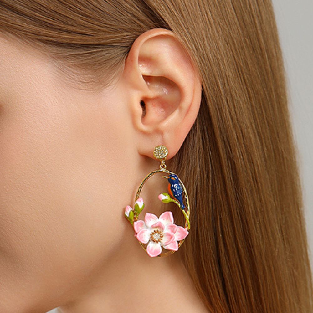 Gold hoop earrings featuring pink enamel lotus flowers and kingfisher bird design