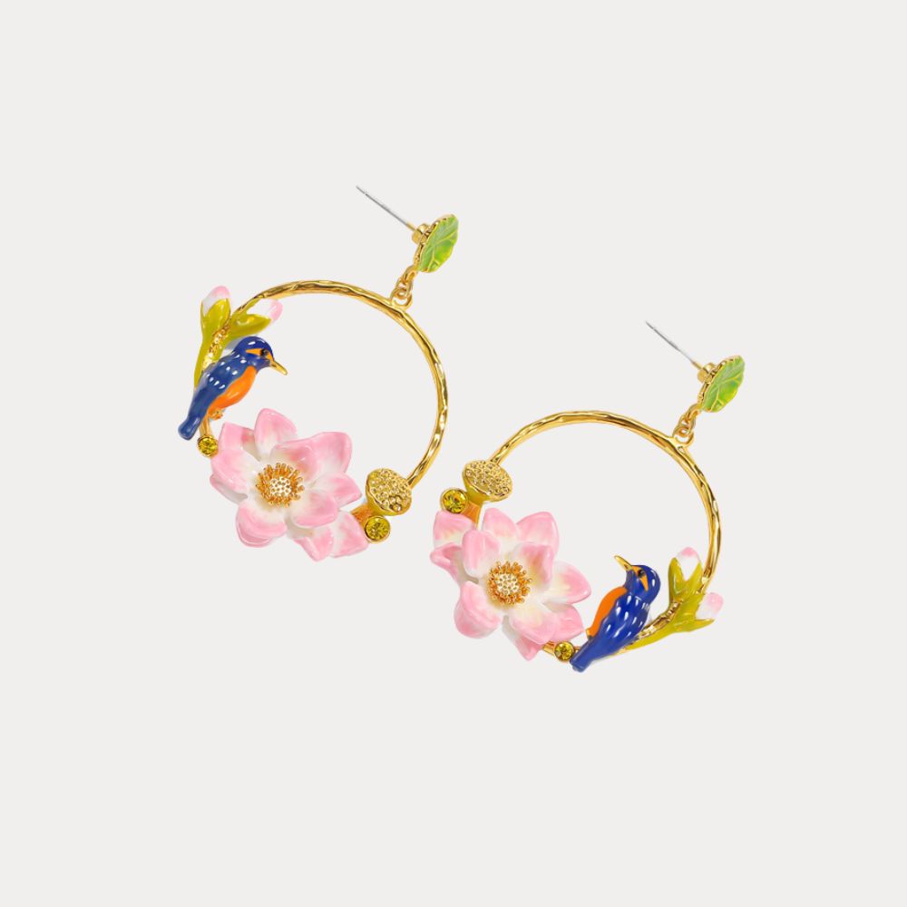 Pair of gold hoop earrings with pink lotus flowers and blue kingfisher birds perched among lotus seed pods, shown at an angle on a white background.