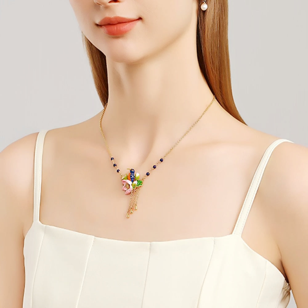 Close-up shot of the Kingfisher Lotus Necklace highlighting its vibrant enamel lotus and bird design.