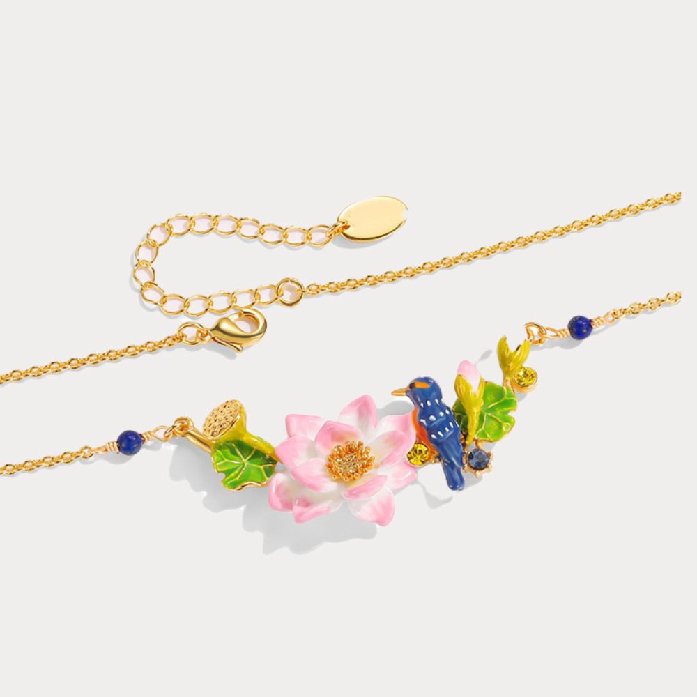 Flat lay image of the Kingfisher Lotus Necklace with golden chain and colorful lotus floral charm centerpiece.