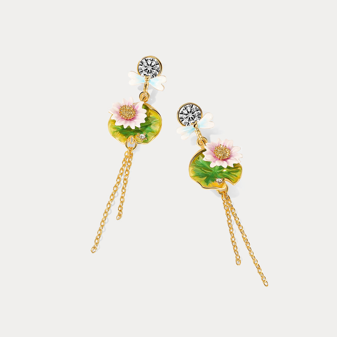  Lotus dragonfly tassel earrings displayed in a diagonal flat lay, highlighting the enamel lotus flowers and intricate chain details.