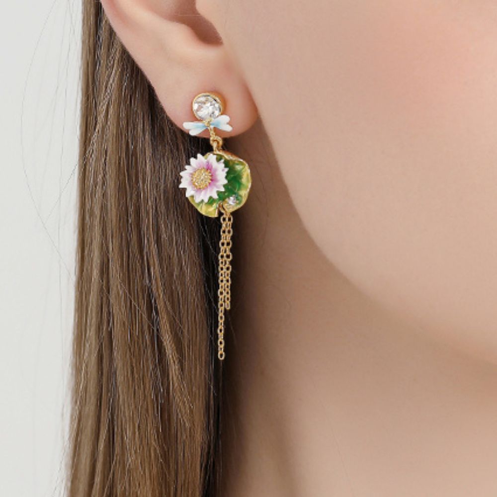 A pair of lotus dragonfly tassel earrings featuring pink lotus flowers on green lily pads with gold-tone chains, displayed on a white background.