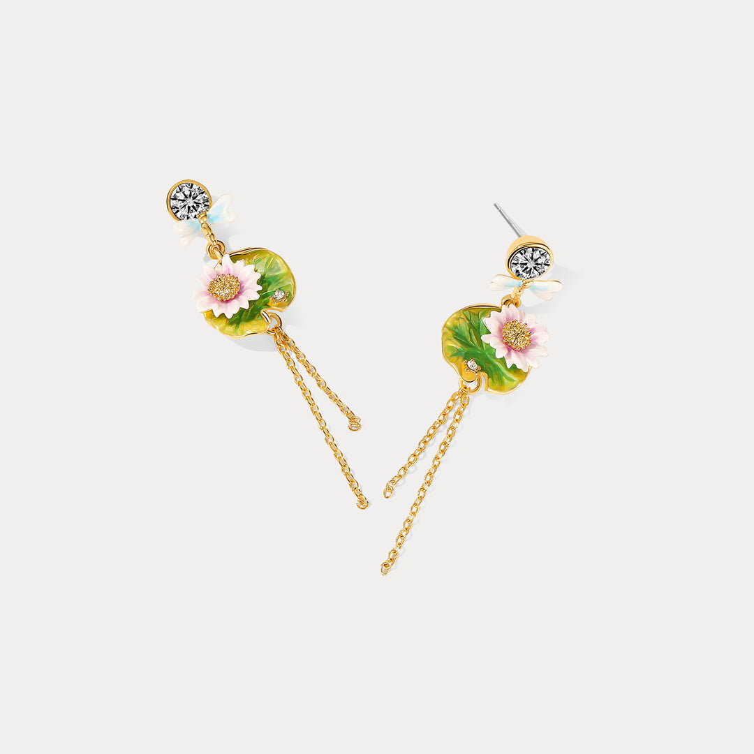 Lightweight lotus dragonfly tassel earrings arranged to show their fluid gold chains and vibrant floral accents.