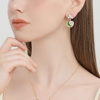 Close-up of a model wearing one lotus dragonfly tassel earring, showing the dangling gold chains and enamel lotus design.
