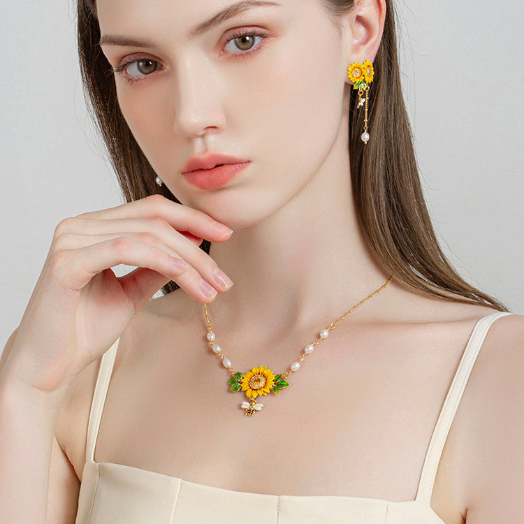 Model showing sunflower pearl pendant necklace paired with dangling sunflower earrings
