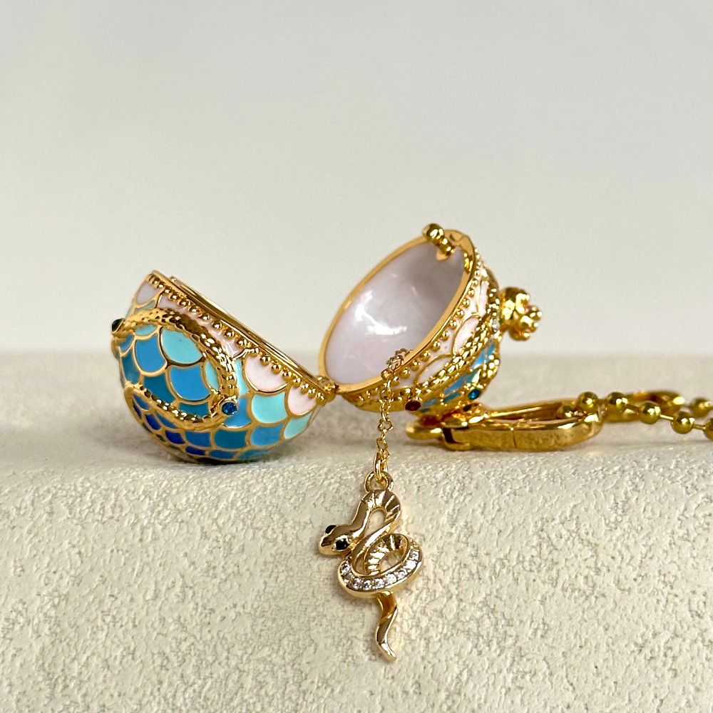 Opened Snake Locket Pendant showing interior with gold snake charm hanging on chain