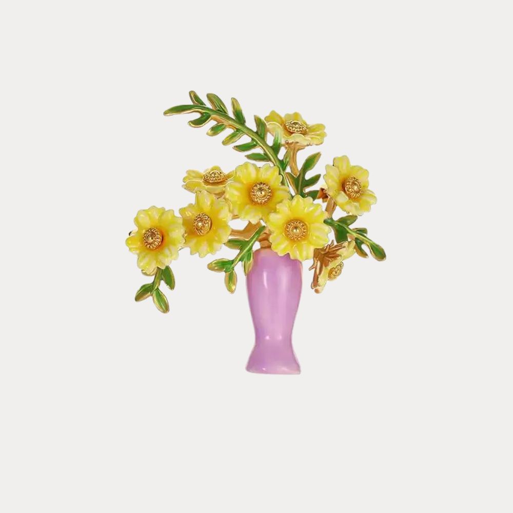 Gold-tone brooch with yellow flowers and green enamel leaves in a lavender vase, viewed from the side