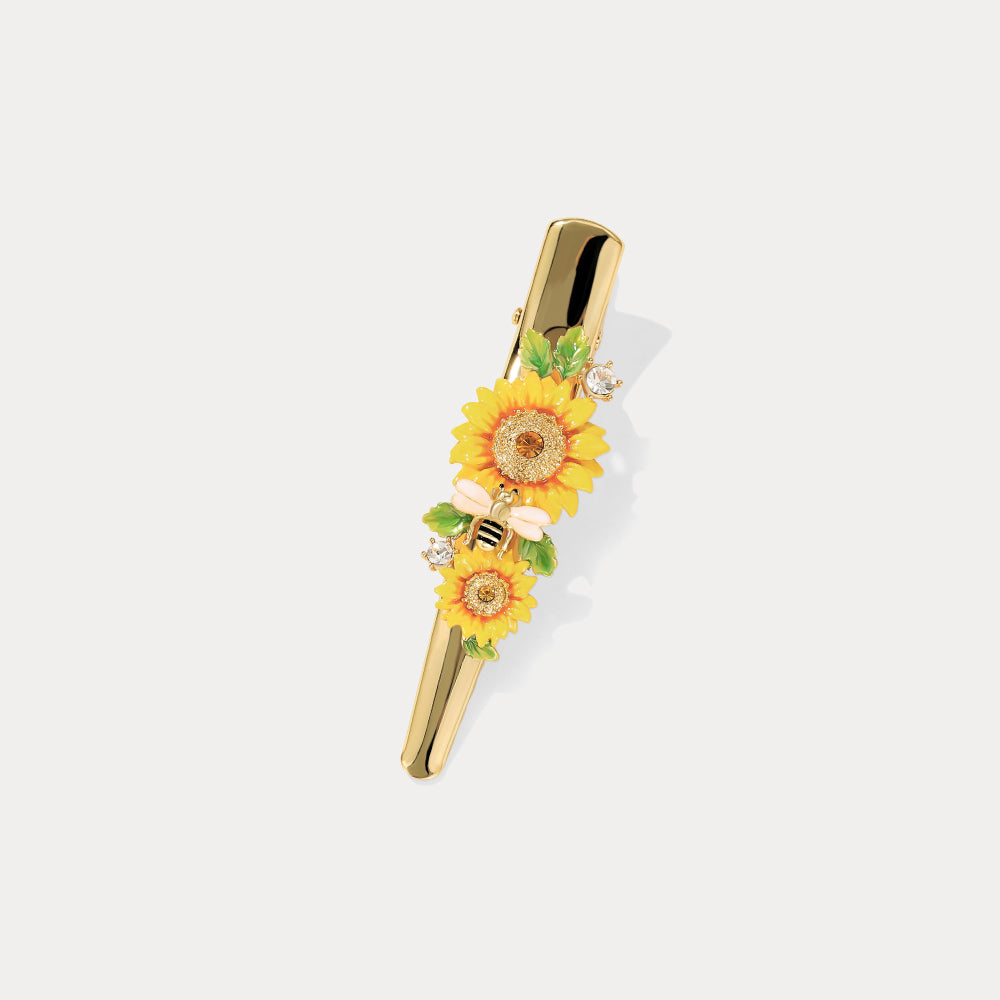 Vertical gold sunflower hairpin featuring bee charm, yellow flowers, and crystal details on white background