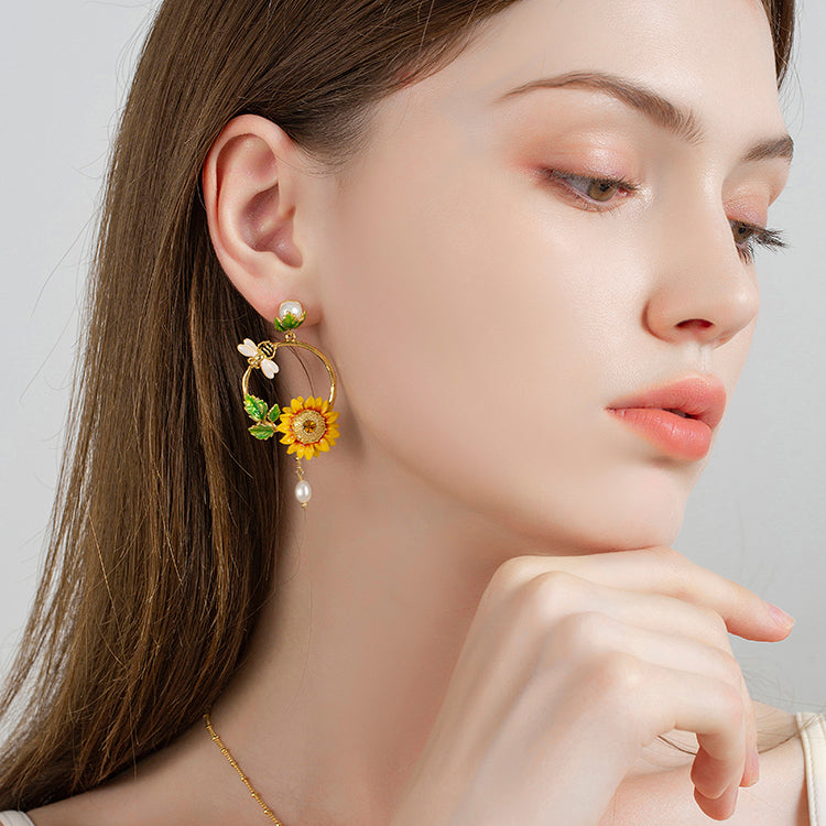 Side profile of model wearing Sunflower Hoop Earrings, emphasizing pearl drop and bee charm