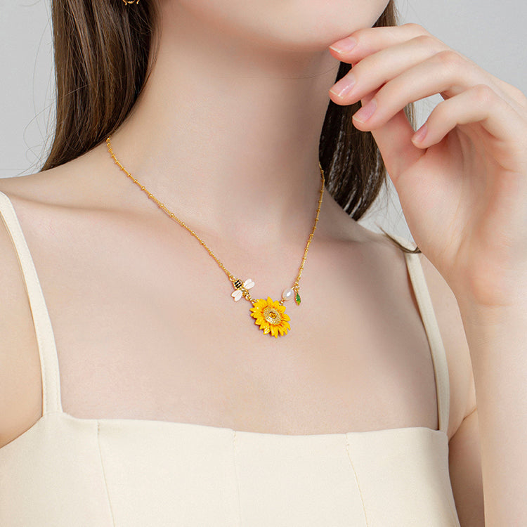 Nature-inspired sunflower pendant necklace displayed on model’s neckline