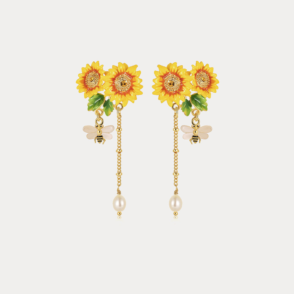 Close-up view of Verdivine's Sunflower Tassel Earrings featuring bright yellow sunflowers, delicate bee charms, and pearl tassels