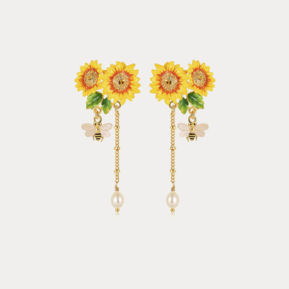 Close-up view of Verdivine's Sunflower Tassel Earrings featuring bright yellow sunflowers, delicate bee charms, and pearl tassels