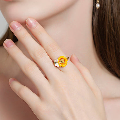 Verdivine sunflower ring with bee charm displayed on hand in an elegant pose